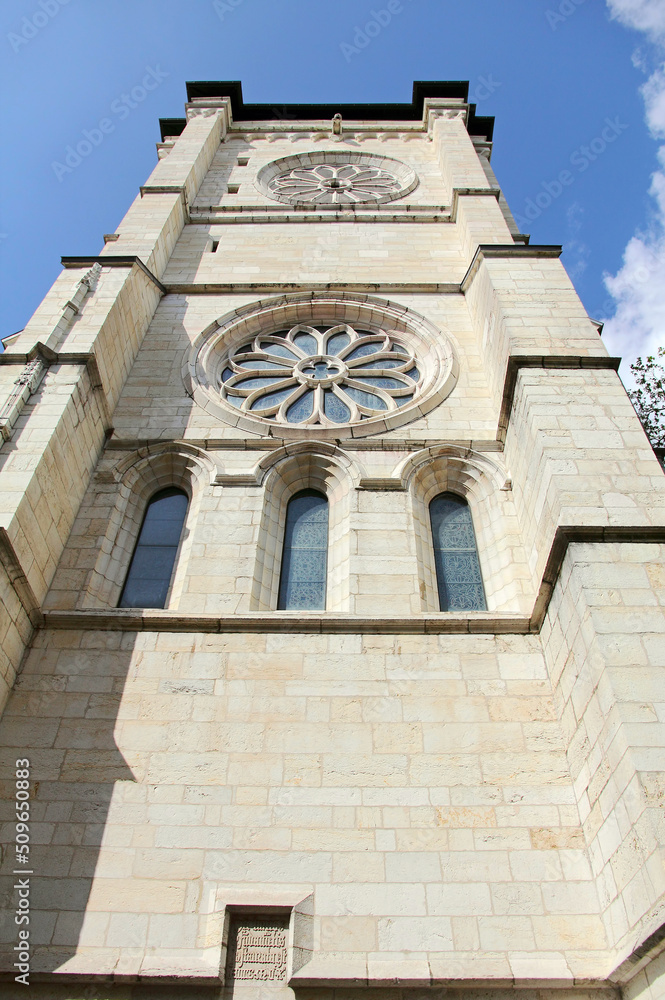 West side tower of the Geneva Saint Pierre Cathedral with stained glass windows.