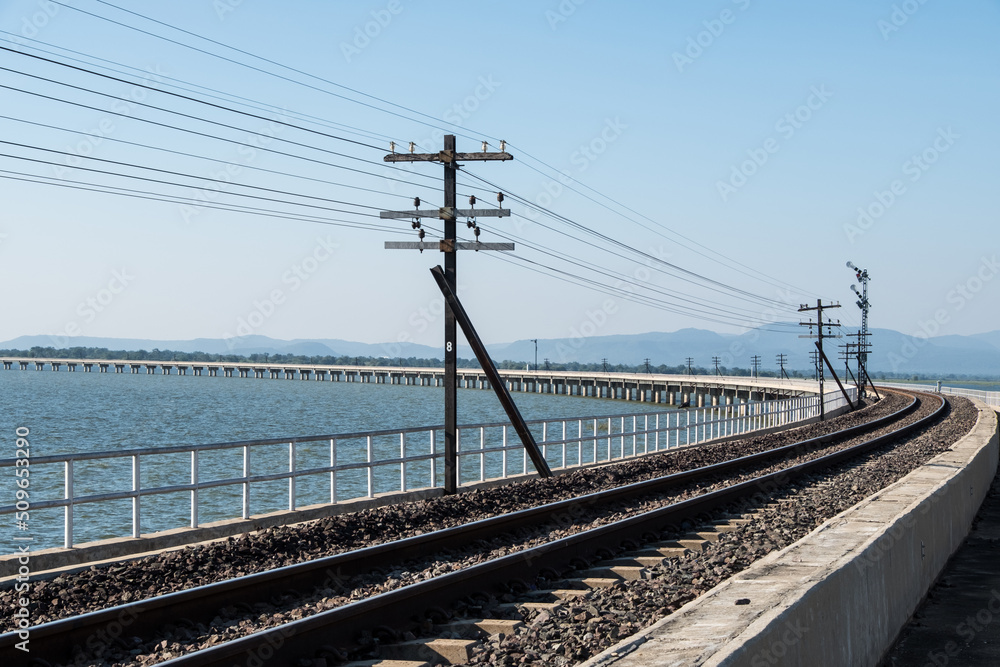 A curved concrete bridge of the railway line along the reservoir. A curved concrete bridge of the railway line along the reservoir.