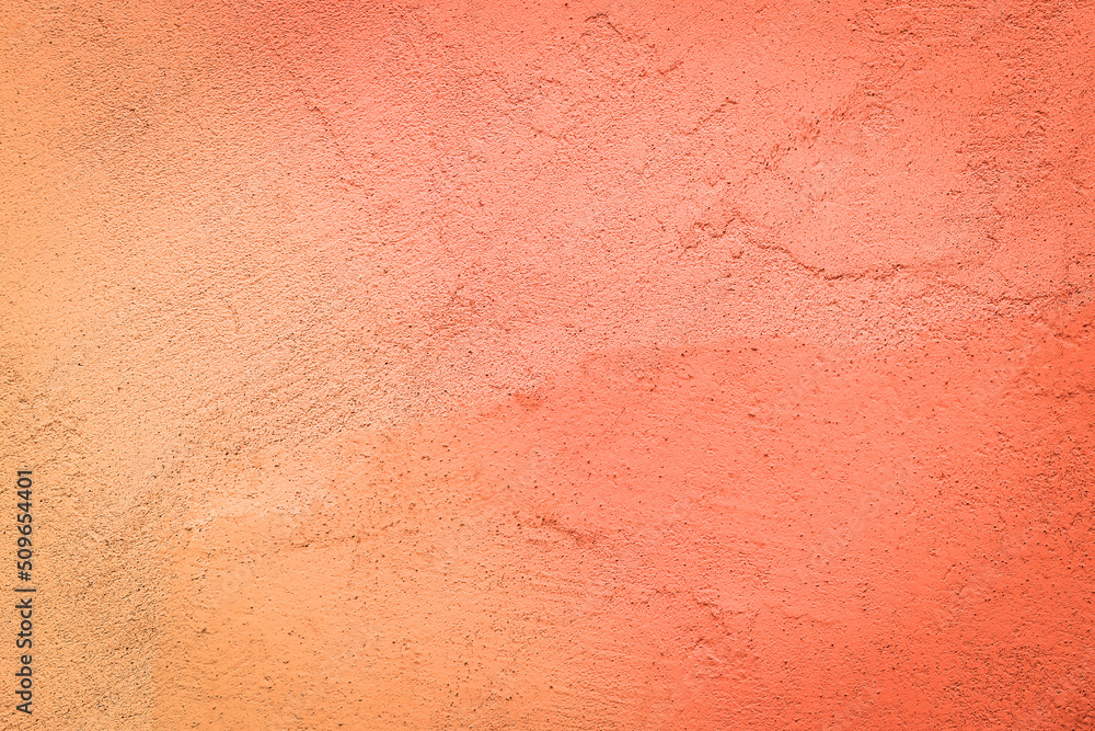 Rough concrete wall painted in orange with brush strokes Rough concrete wall painted in orange with brush strokes