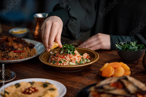 Tabbouleh Vegetable Salad close-up, middle eastern national traditional food. Muslim family dinner, Ramadan, iftar. Arabian cuisine.