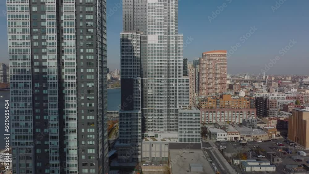 Fly around high rise apartment buildings on East river waterfront. Residential borough in city. Queens, New York City, USA Fly around high rise apartment buildings on East river waterfront. Residential borough in city. Queens, New York City, USA