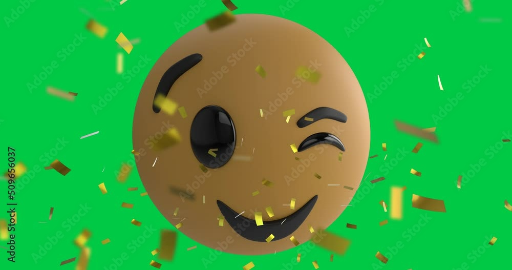 Confetti falling over winking face emoji against copy space on green background Confetti falling over winking face emoji against copy space on green background