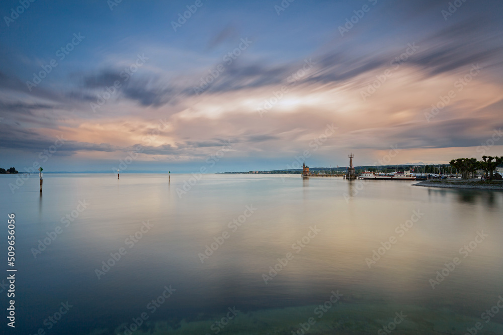 Constance, Germany - Old lighthouse and big statue of Imperia in harbor of Konstanz. Imperia is a landmark of the city. Panoramic view of Constance Lake (Bodensee) in summer. Constance, Germany - Old lighthouse and big statue of Imperia in harbor of Konstanz. Imperia is a landmark of the city. Panoramic view of Constance Lake (Bodensee) in summer.