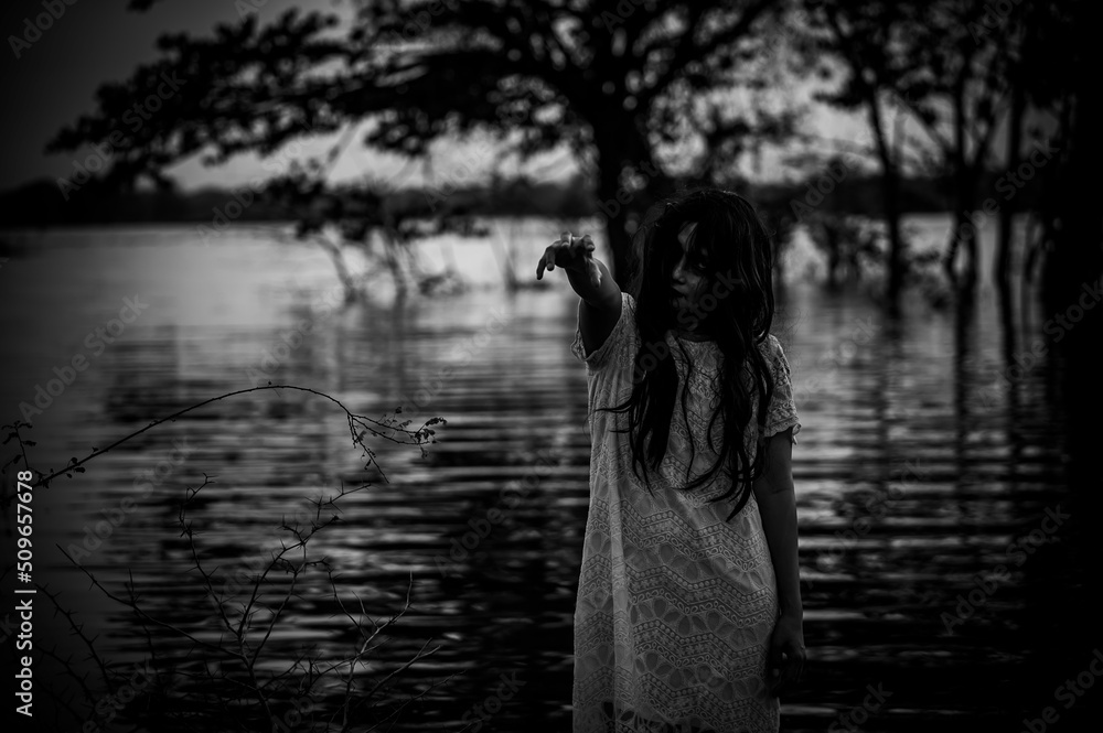 Portrait of asian woman make up ghost face at the swamp,Horror in water scene,Scary at river,Halloween poster,Thailand people Portrait of asian woman make up ghost face at the swamp,Horror in water scene,Scary at river,Halloween poster,Thailand people