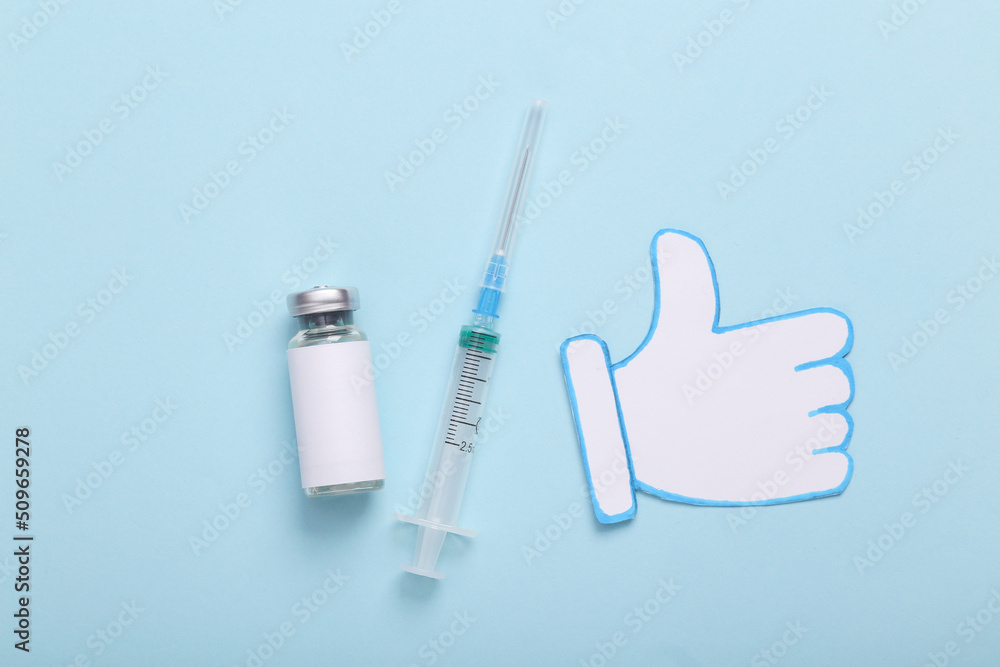 Vaccine bottle with syringe and thumb up icon on blue background Vaccine bottle with syringe and thumb up icon on blue background