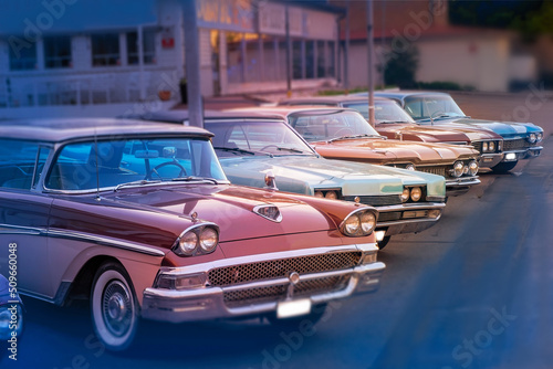 several old restored cars of different colors, in the light of the setting sun © AstridAve