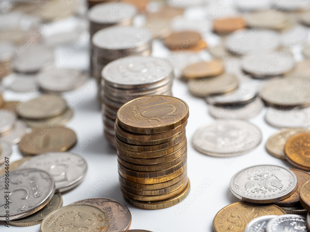 Close-up of a lot of Russian ruble coins on a white background. Columns of coins. The concept of the economy of growth, development. Budget, currency. Risks, banks Close-up of a lot of Russian ruble coins on a white background. Columns of coins. The concept of the economy of growth, development. Budget, currency. Risks, banks
