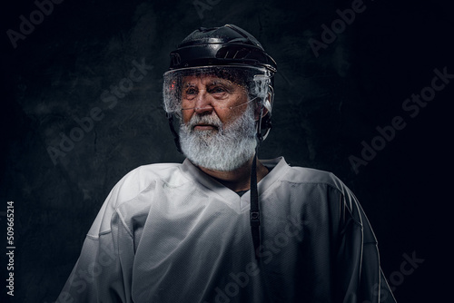 Photography Shot of old sportsman with long beard dressed in white sportswear and helmet