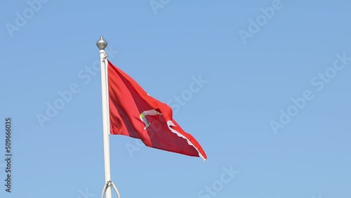 Manx flag flying on a pole. Douglas, Isle of Man photo