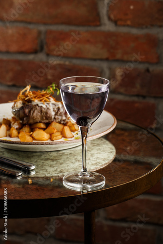 Obraz na płótnie Grilled steak with baked golden potatoes served with crispy onion on top on a brick background. Delicious Recipe. w salonie