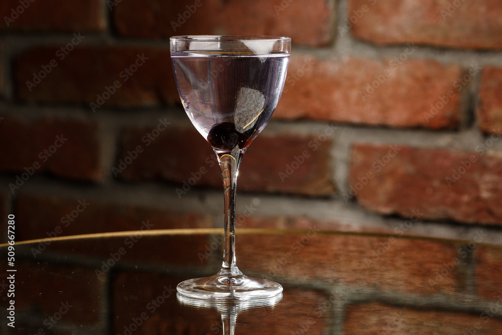 Aviation, drink with gin, lemon juice, maraschino liqueur and violet cream liqueur standing on bar counter.