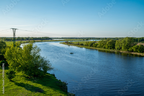 River with green shores under blue sky