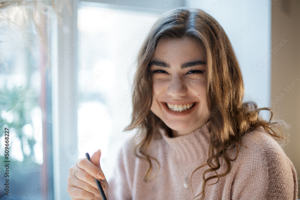 Portrait of young smiling woman looking at camera. Portrait of young smiling woman looking at camera.