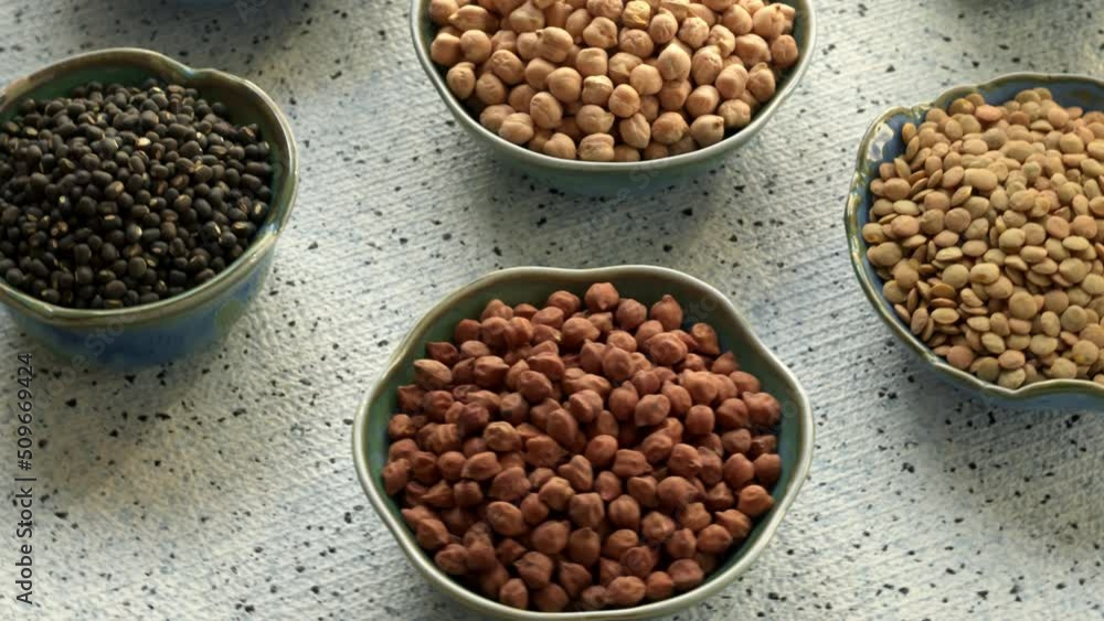Assortment of dry chickpea and lentils in bowls. Table spin. Assortment of dry chickpea and lentils in bowls. Table spin.