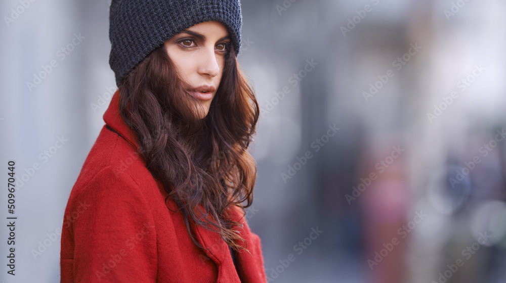 When in doubt wear red. Shot of a beautiful young woman in winter clothing standing in an urban setting. When in doubt wear red. Shot of a beautiful young woman in winter clothing standing in an urban setting.