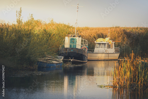 old fishing boats on the river bank