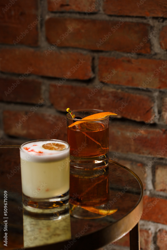 Pisco sour cocktail - whiskey with lime, egg white, sugar syrup in glass on dark background. Space for text