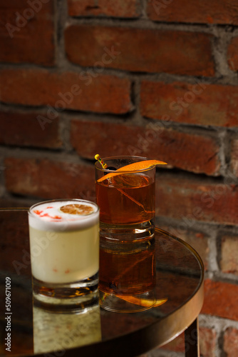 Obraz na płótnie Pisco sour cocktail - whiskey with lime, egg white, sugar syrup in glass on dark background. Space for text w salonie