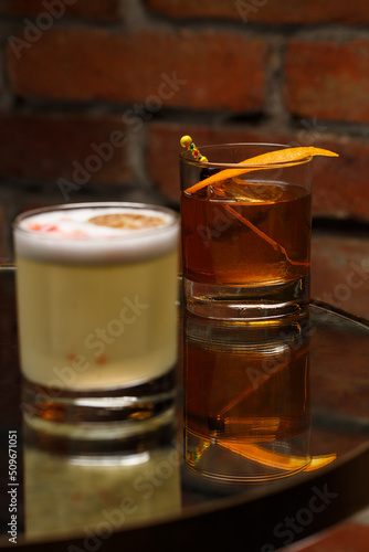 Obraz na płótnie Pisco sour cocktail - whiskey with lime, egg white, sugar syrup in glass on dark background. Space for text w salonie