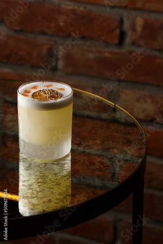 Obraz na płótnie Pisco sour cocktail - whiskey with lime, egg white, sugar syrup in glass on dark background. Space for text w salonie