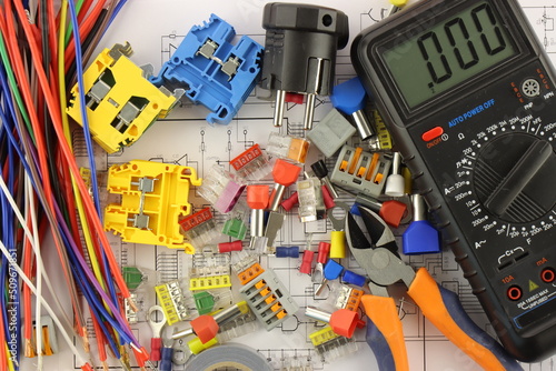 Multimeter and tools for installing an electrical control panel in close-up on an electrical diagram. © Нелик Дулатов