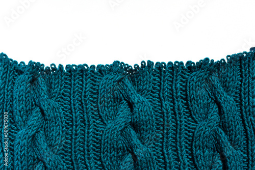 Hand knitted knitted fabric made of thick yarn with open loops on a white background. Braid pattern knitting. unravel Related Thing