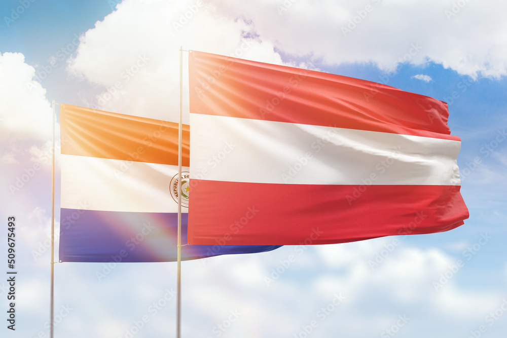 Sunny blue sky and flags of austria and paraguay Sunny blue sky and flags of austria and paraguay
