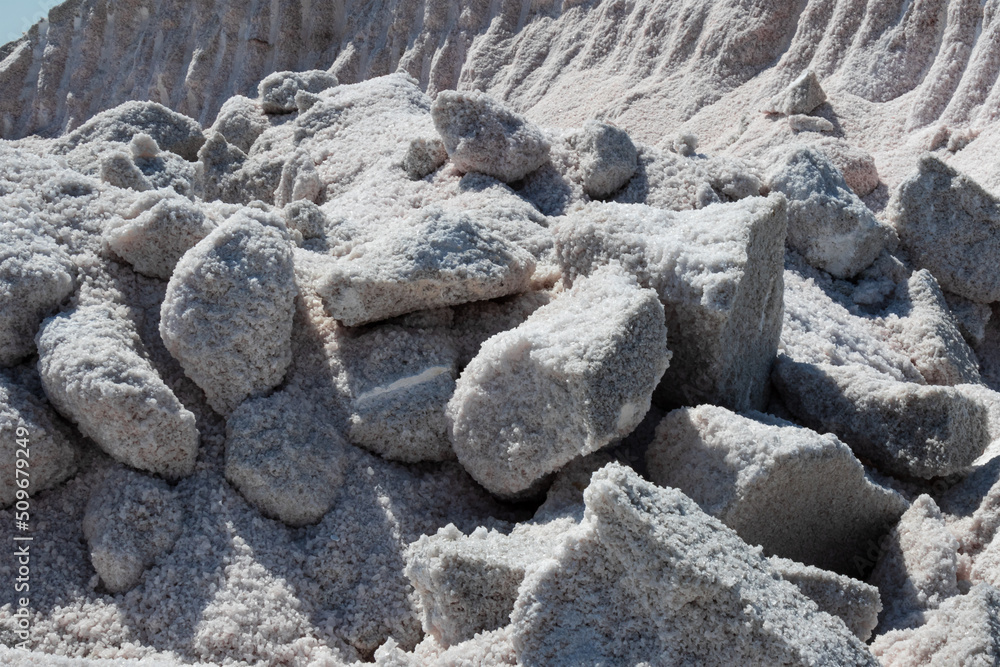huge pieces of mined rock salt on the shore of the salt lake



