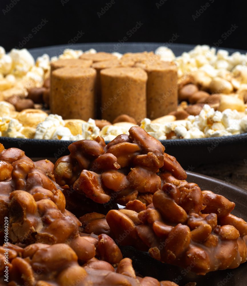 June party: Peanut candy, popcorn, peanuts and paçoca on rustic wooden background June party: Peanut candy, popcorn, peanuts and paçoca on rustic wooden background