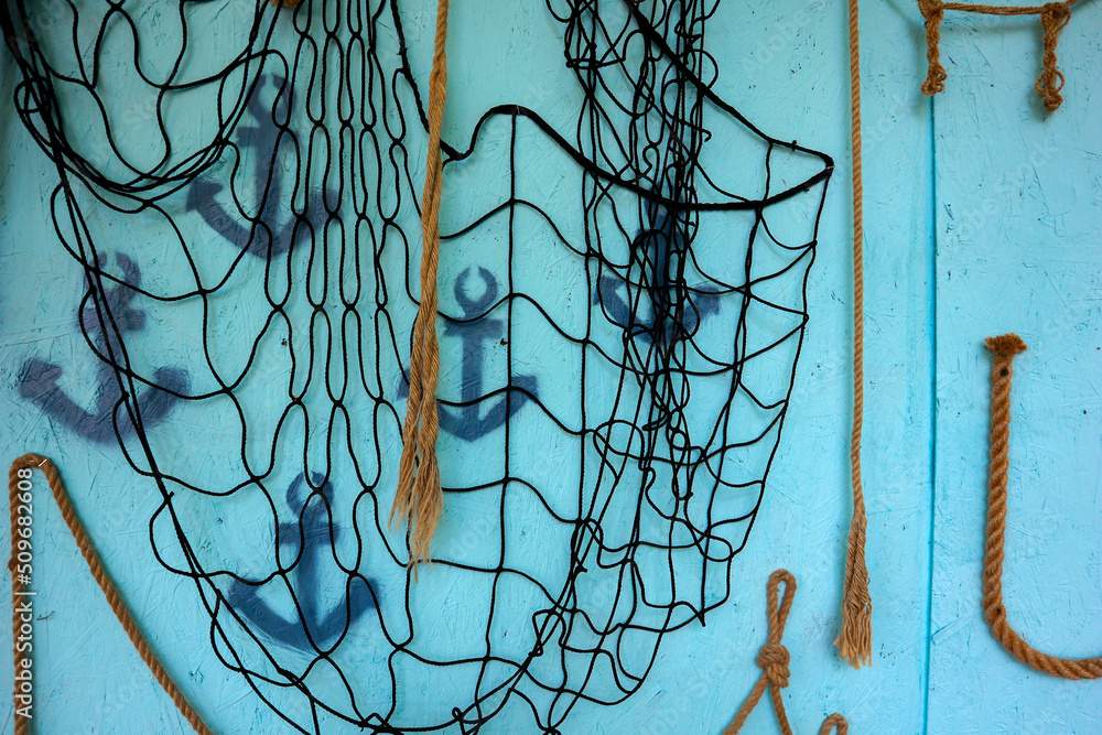 a wall with ropes in a nautical style.net, ropes, ropes, anchors. decorations a wall with ropes in a nautical style.net, ropes, ropes, anchors. decorations