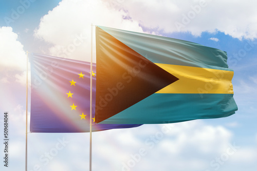 Sunny blue sky and flags of bahamas and european union