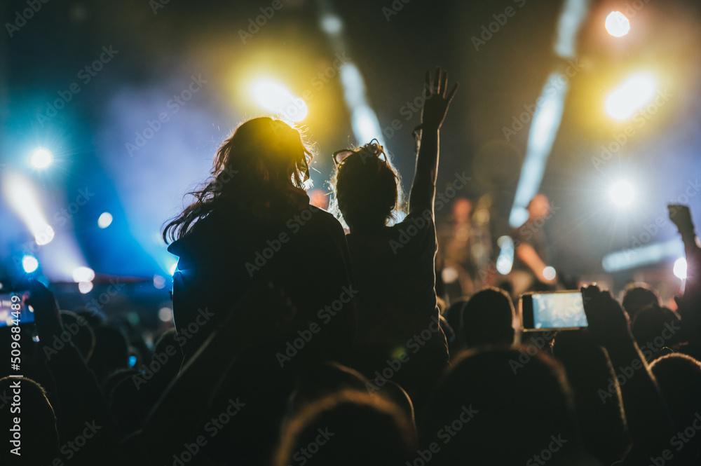 Two woman in the crowd at a music festival