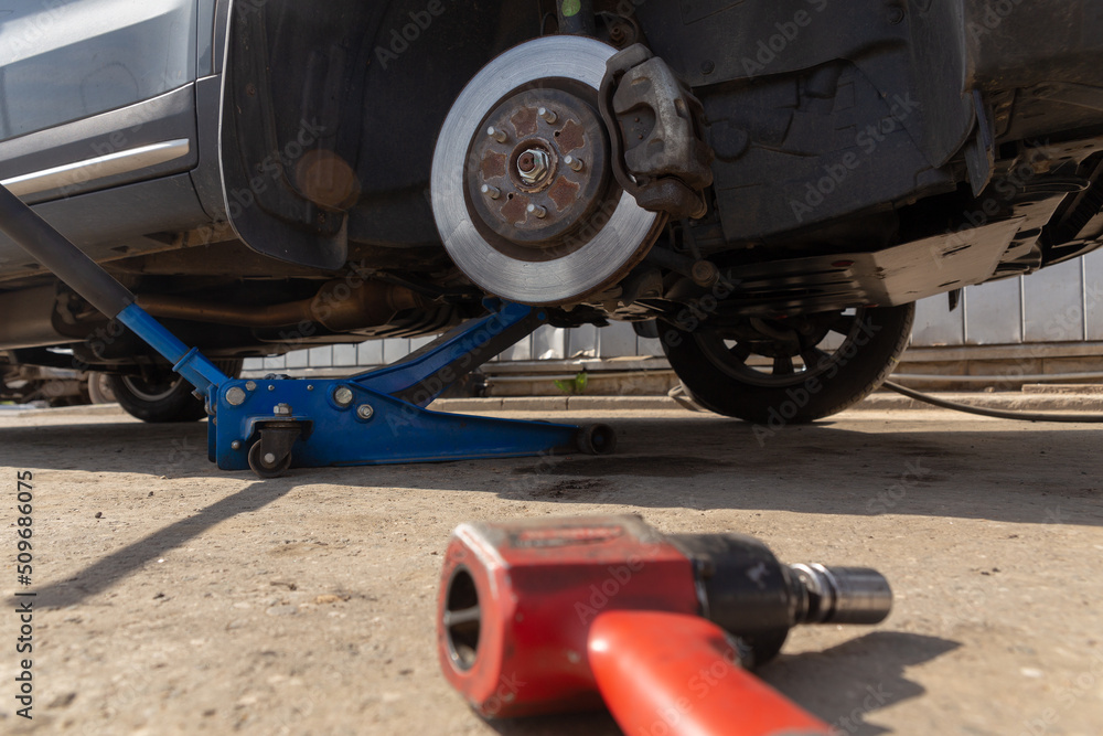 Hydraulic car jack lift the new car for change the tyre. Hydraulic car jack lift the new car for change the tyre.