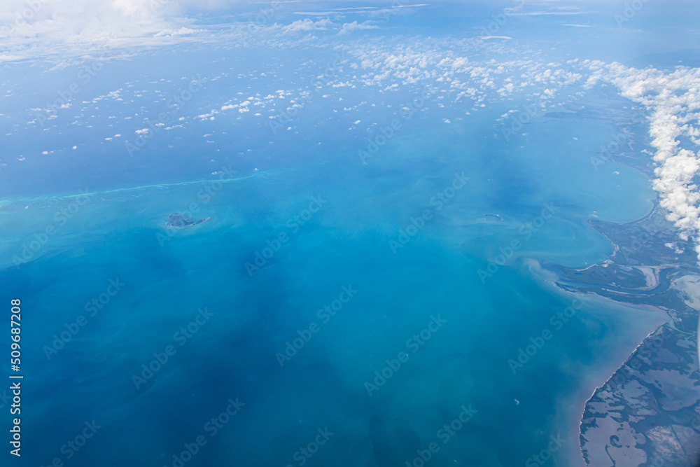 Aerial view of blue ocean and coast land with a few clouds Aerial view of blue ocean and coast land with a few clouds