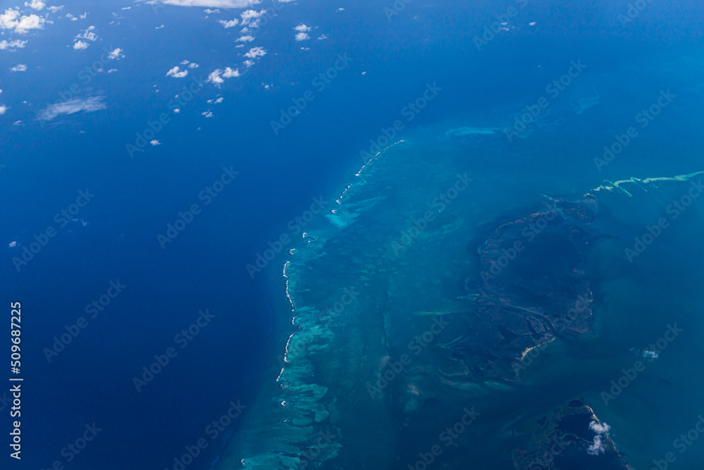 Aerial view of blue ocean and underwater landmarks with a few clouds Aerial view of blue ocean and underwater landmarks with a few clouds