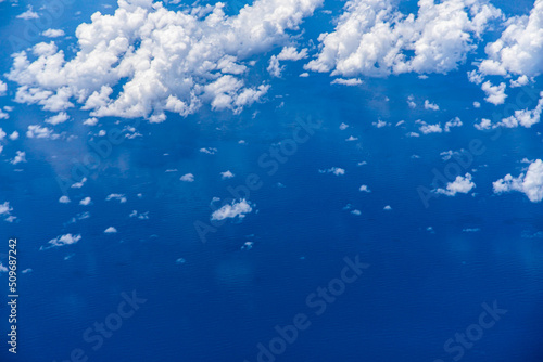 Konstfotografi Aerial view of blue ocean with clouds and reflection