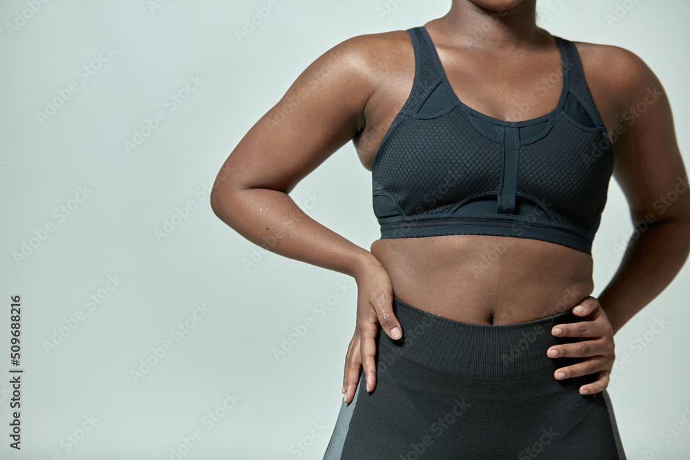 African american girl wearing sportive clothes showing torso with fat folds, closeup, copyspace. Body positive, slimming