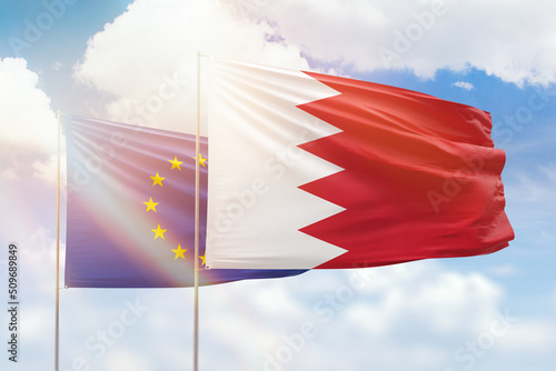 Sunny blue sky and flags of bahrain and european union
