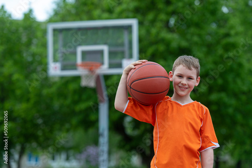 Boy playing basketball on a park court. Concept of a sports lifestyle, training, camp, leisure, vacation. Horizontal sport theme poster, greeting cards, headers, website and app © Augustas Cetkauskas