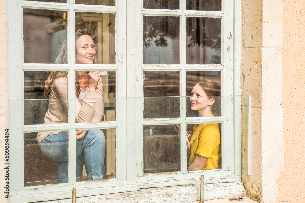 Caucasian woman talking with her teenage daughter during the morning together Caucasian woman talking with her teenage daughter during the morning together