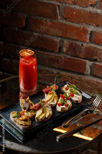 Obraz na płótnie Bruschettas with vegetables. Start dishes with cherry tomatoes, avocado, cream cheese and shrimps. Food composition, tasty italian meal w salonie