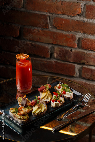 Obraz na płótnie Bruschettas with vegetables. Start dishes with cherry tomatoes, avocado, cream cheese and shrimps. Food composition, tasty italian meal w salonie