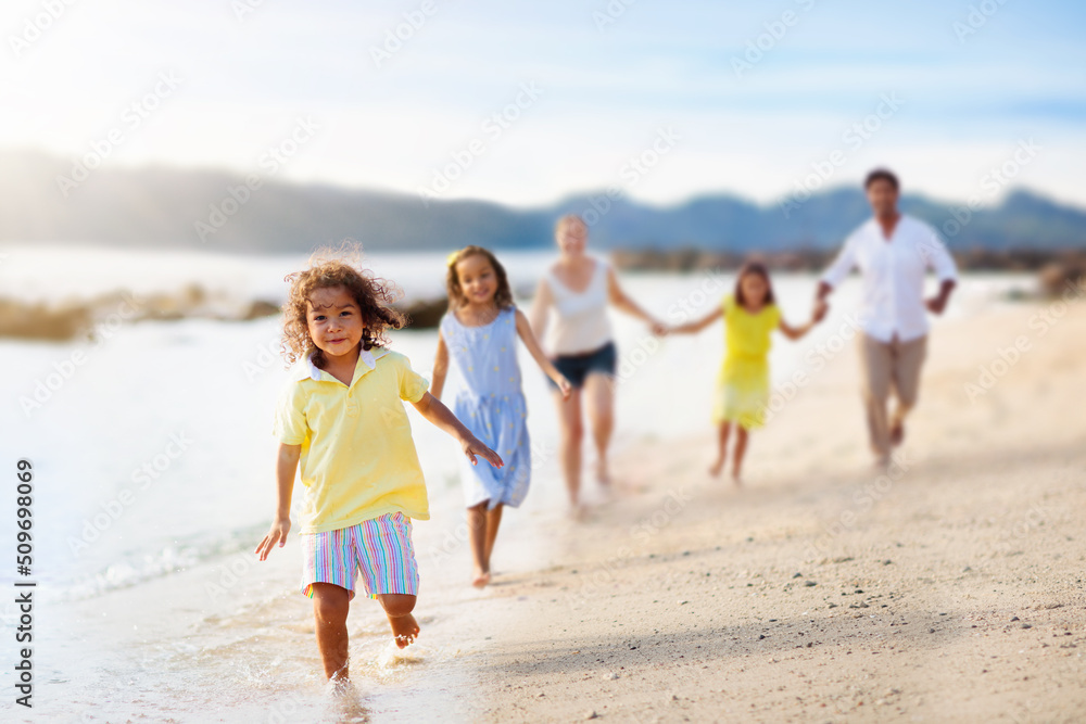 Family walking on tropical beach.