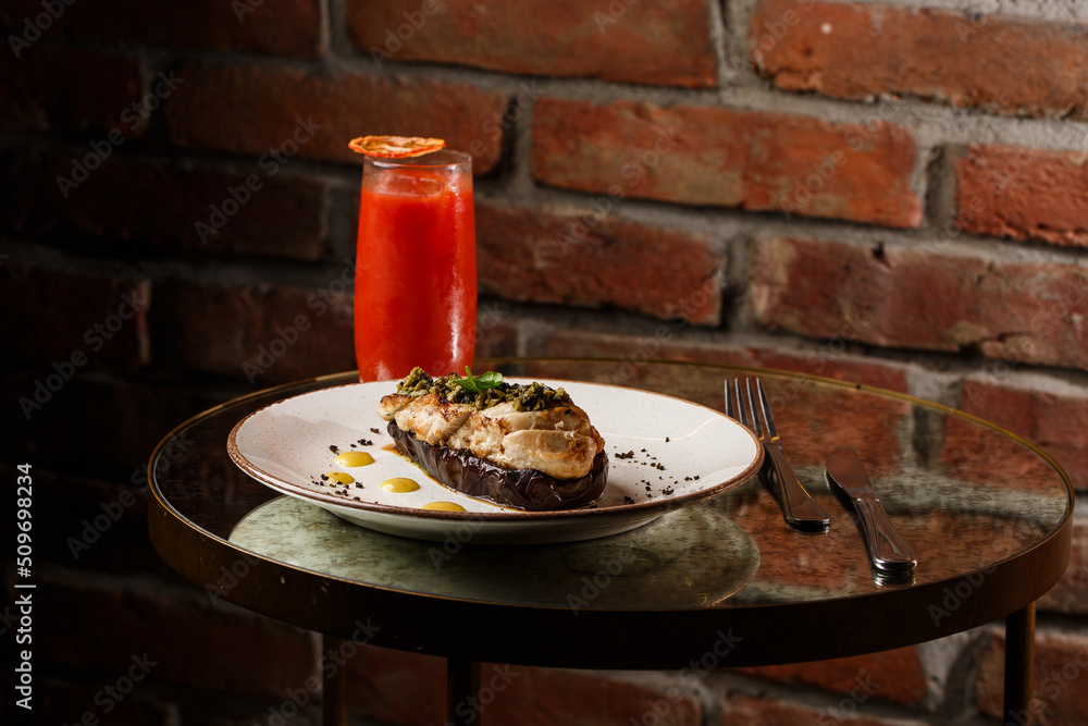 Baked eggplant stuffed with grilled chicken, tomatoes and spices on white plate. Traditional dish Karniyarik of turkish cuisine. View from above
