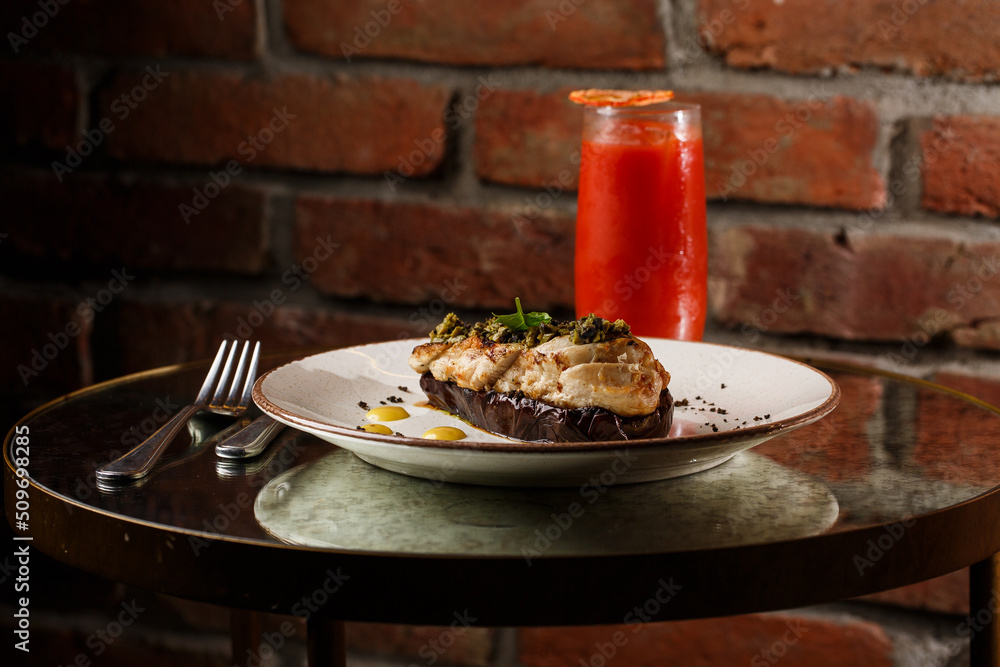 Baked eggplant stuffed with grilled chicken, tomatoes and spices on white plate. Traditional dish Karniyarik of turkish cuisine. View from above