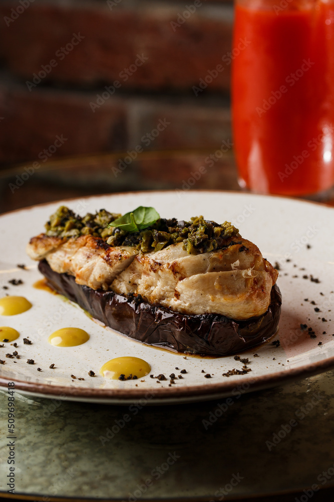 Baked eggplant stuffed with grilled chicken, tomatoes and spices on white plate. Traditional dish Karniyarik of turkish cuisine. View from above