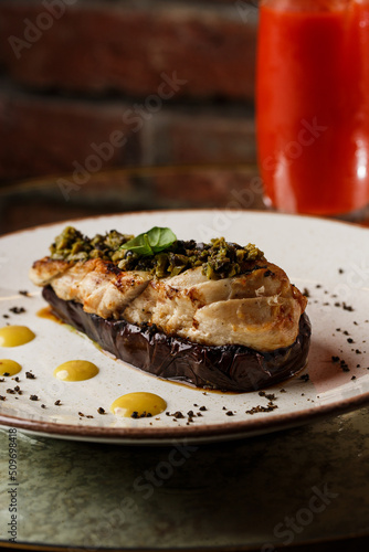 Obraz na płótnie Baked eggplant stuffed with grilled chicken, tomatoes and spices on white plate. Traditional dish Karniyarik of turkish cuisine. View from above w salonie