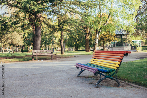 Fotobehang LGBTQ rainbow painted bench in a park on sunny summer day as a support of LGBTIQ