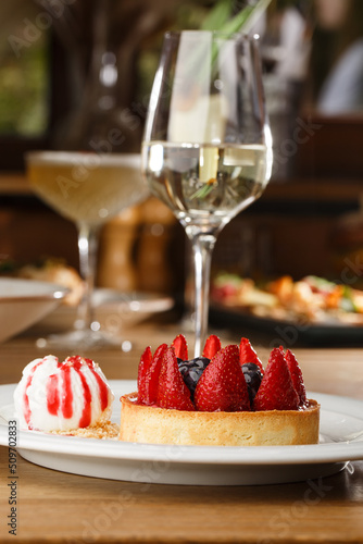 Obraz na płótnie Berry tartlets with curd cream on a wooden background. Summer fruit baking. Tartlets with raspberries, blueberries and red currants. Served with ice cream. w salonie