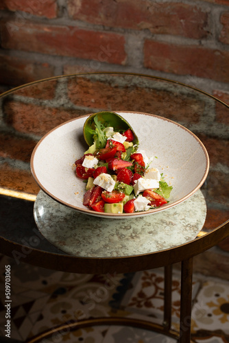 Obraz na płótnie Tasty and healthy salad with arugula, brie cheese, avocado, cherry tomatoes and strawberry. Top view. The flat lay. Banner w salonie